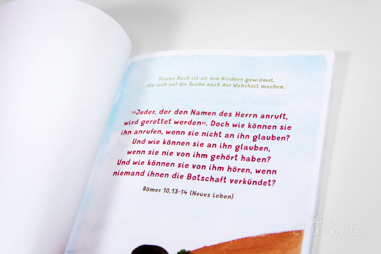 Geöffnete Buchseite mit Bibelzitat aus Römer 10,13-14 und Wi