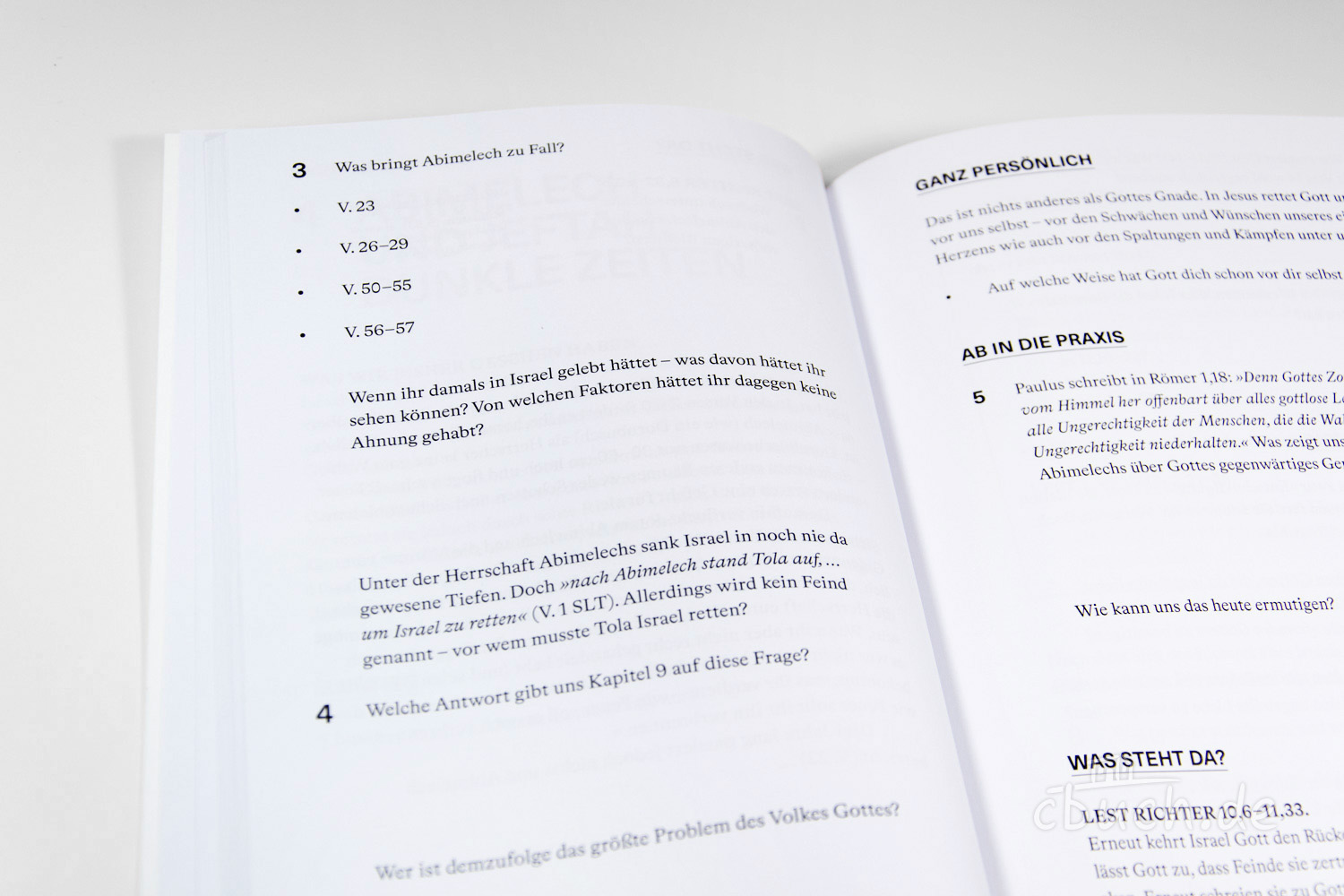 Blick auf ein aufgeschlagenes Buch mit biblischen Fragen und