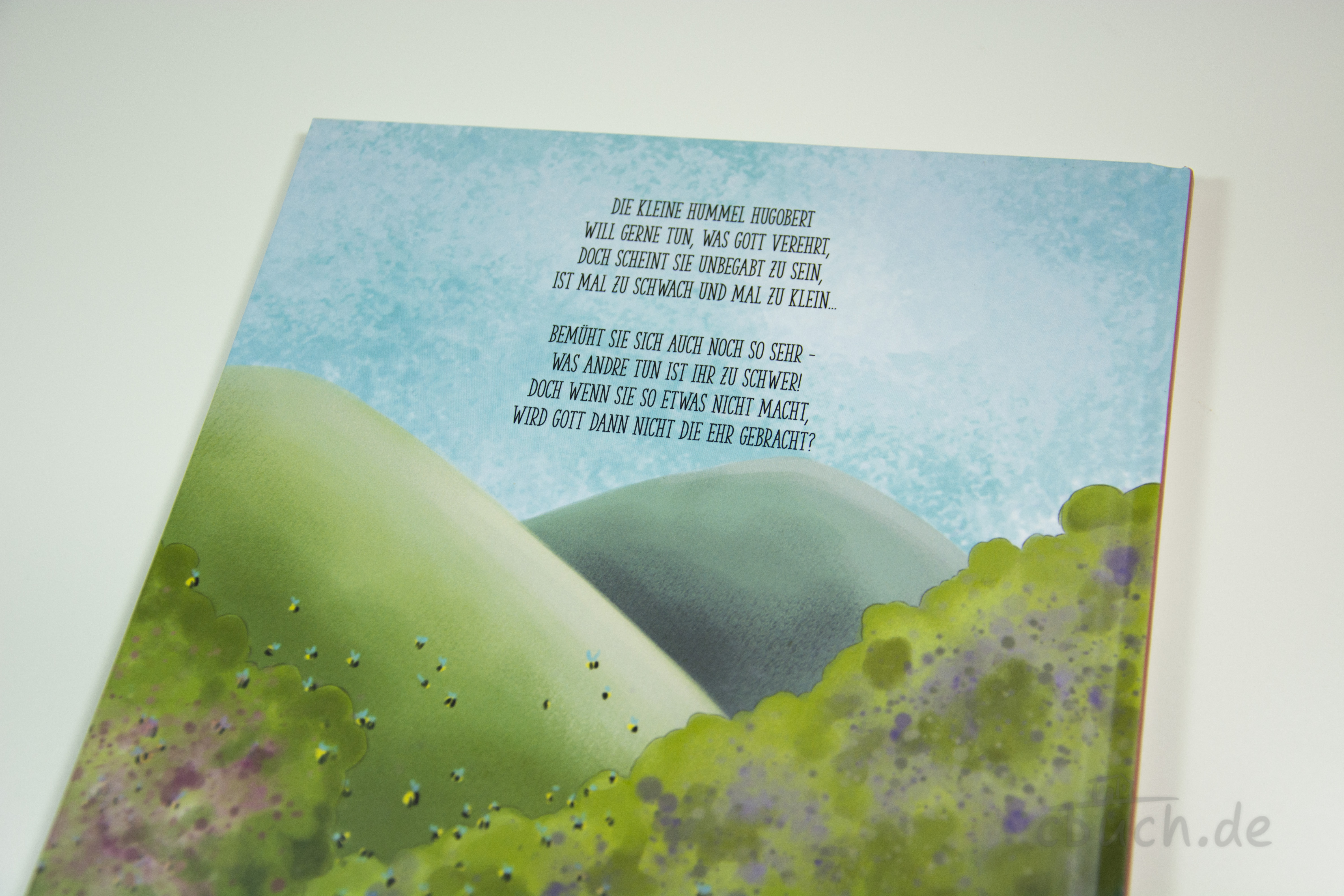 Hugobert - die unbegabte Hummel, Kinderbuch von CMV mit gereimter Mutmach-Geschichte Aufgeschlagenes Kinderbuch „Hugobert - die unbegabte Hummel“ von CMV mit gereimtem Text und sanfter Landschaftsillustration, eine mutmachende Vorlesegeschichte für Groß und Klein