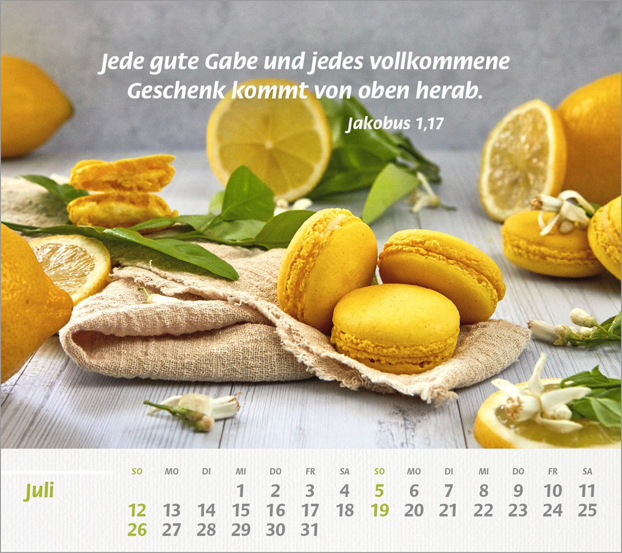 Zitronen-Macarons neben frischen Zitronen auf hellem Holztis